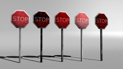 Five grungy and worn stop signs